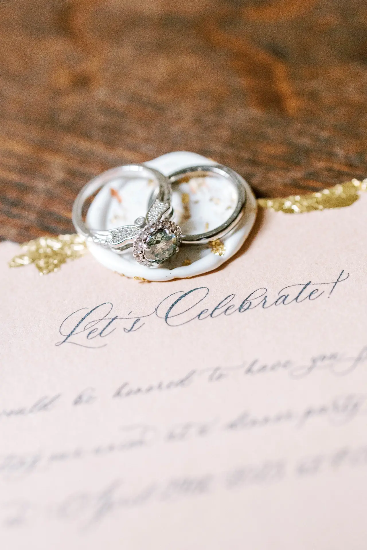 Wedding details card with a pair of engagement rings set on it